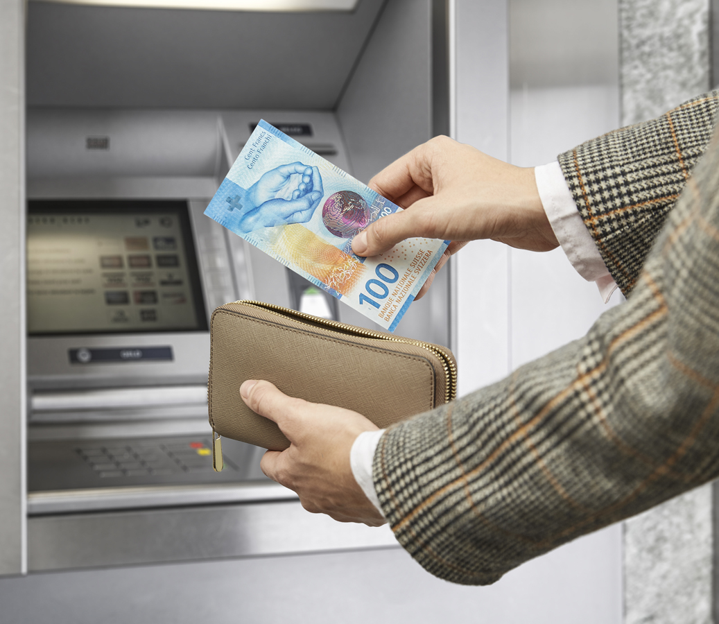 100-franc notes being withdrawn from an ATM